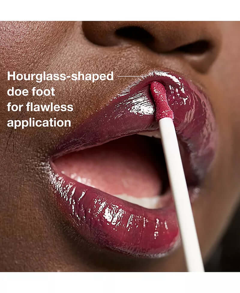 Close-up of lips applying rich beauty product with hourglass-shaped doe foot for flawless application.